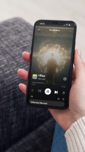 woman-holding-phone-with-spotify-image-i-rise